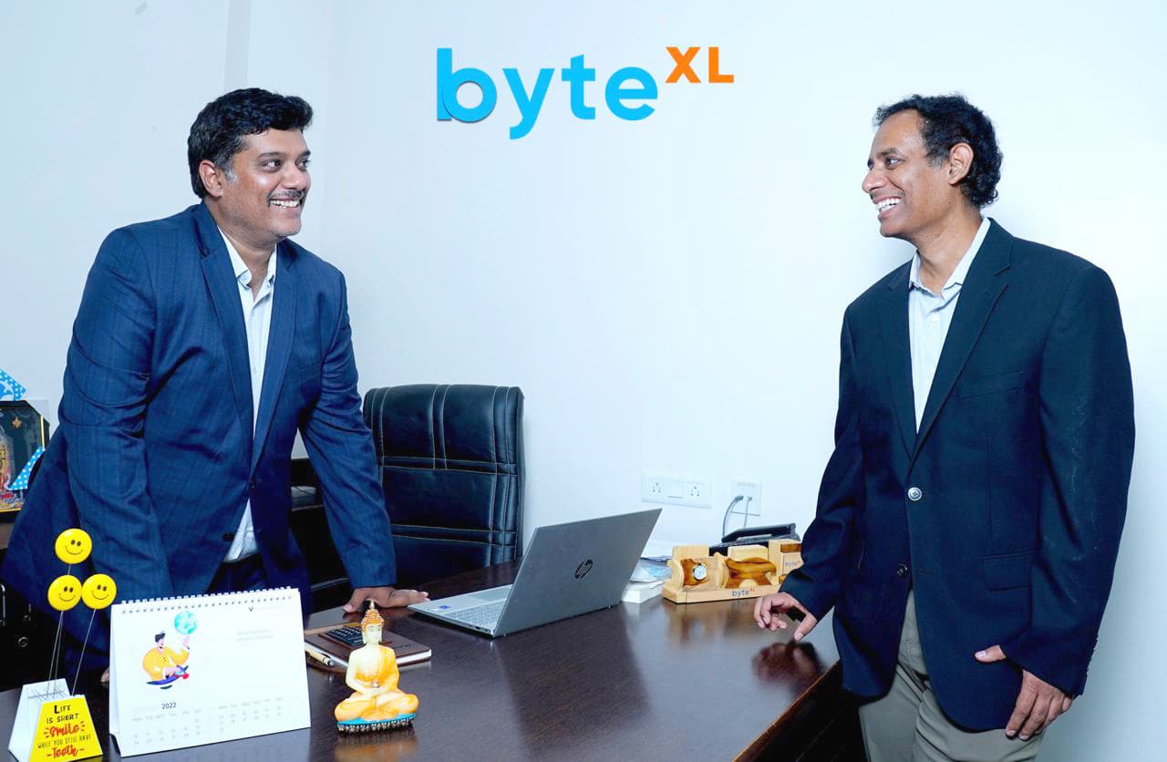 byteXL founders Karun and Sricharan Tadepalli talking in the office